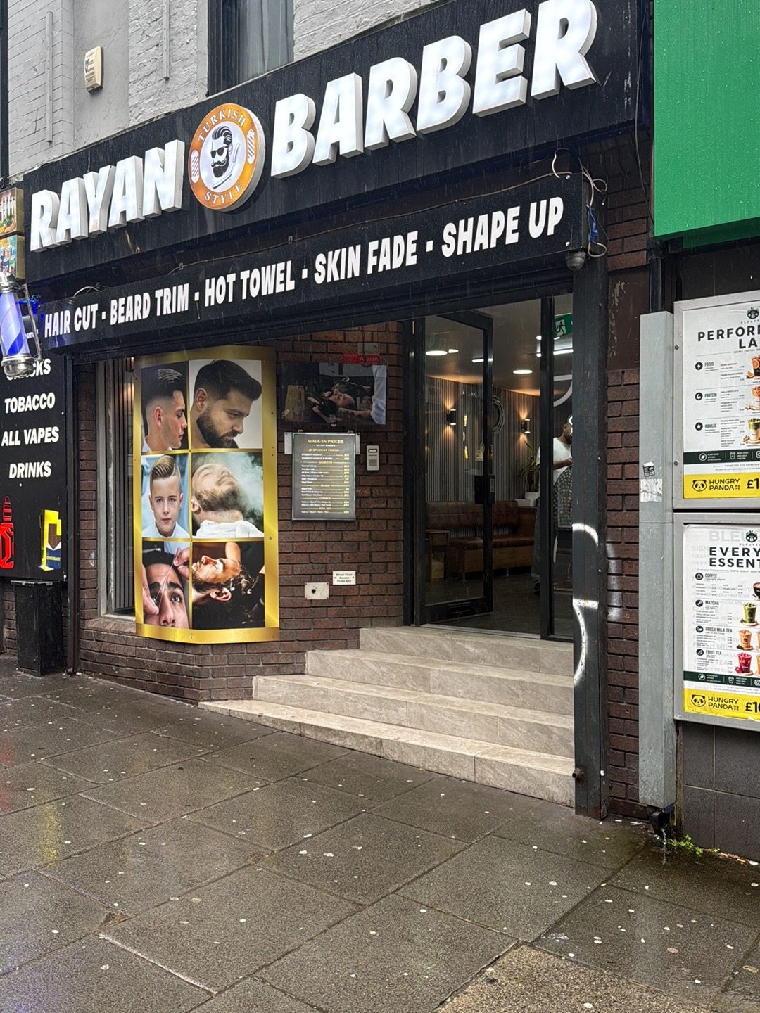 The Rayan Barber shopfront on Mount Pleasant, with the shop name across a black fascia