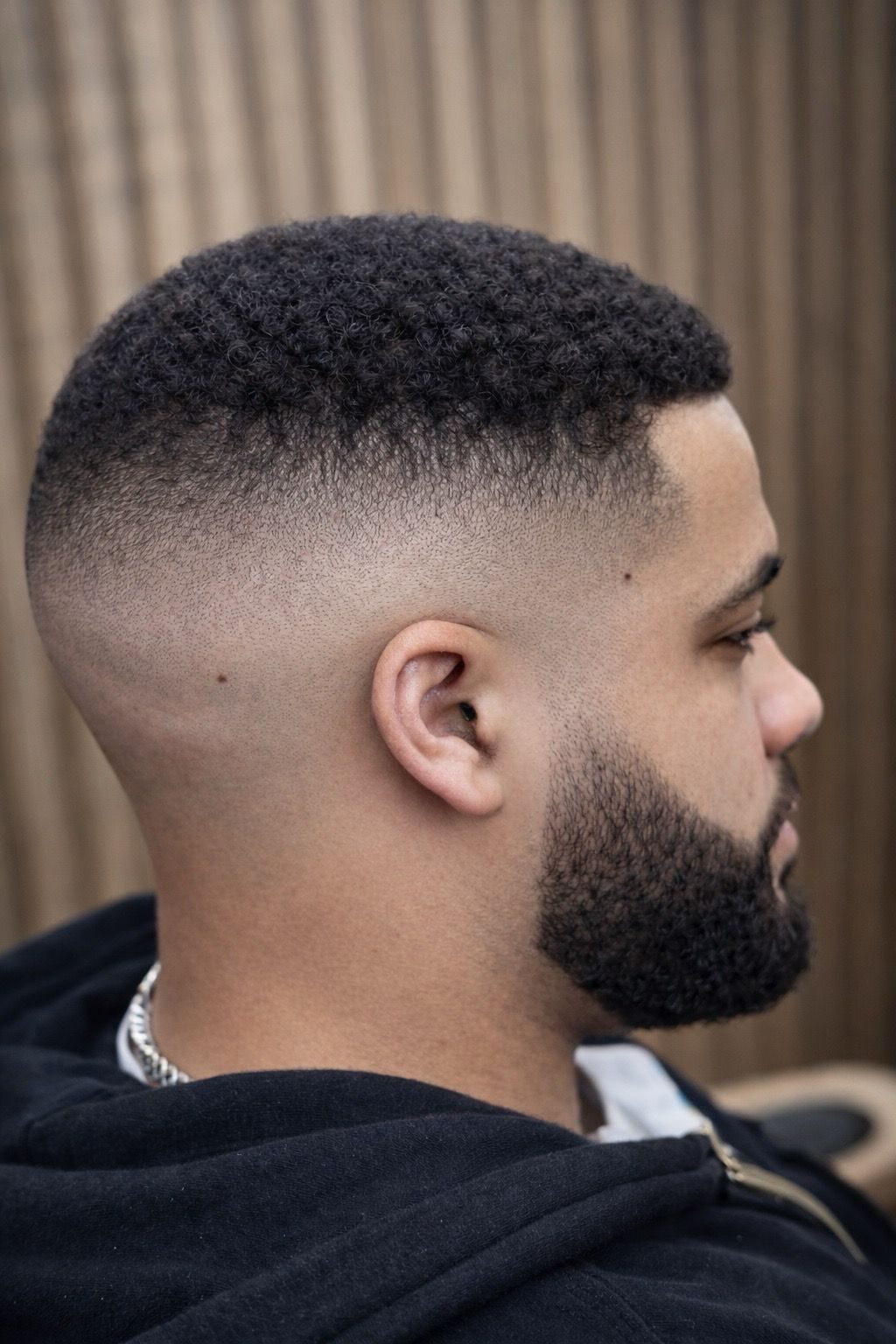 A sharp skin fade with a lined up beard, cut at Rayan Barber